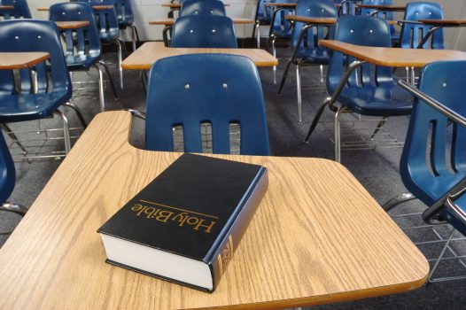 Bible on a school desk in a classroom. Bible on a school desk in a classroom.