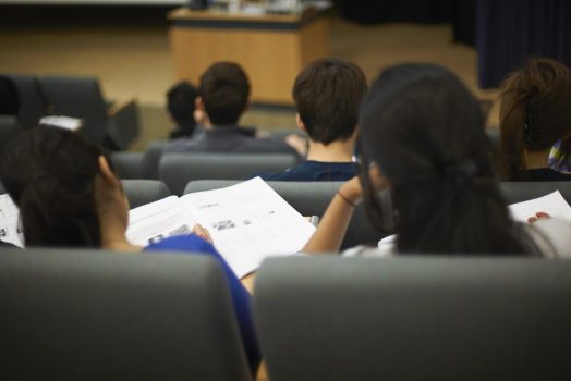 Students reading book in class