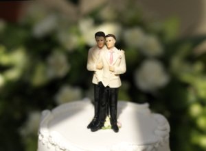 Figurines, depicting a gay wedding or Civil Partnership, on top of a wedding cake, narrow focus on the head.