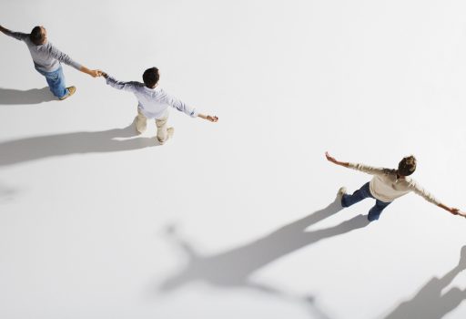 Two pairs of people holding hands, gap between pairs, overhead view