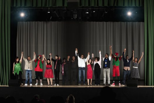 Students bowing on high school stage