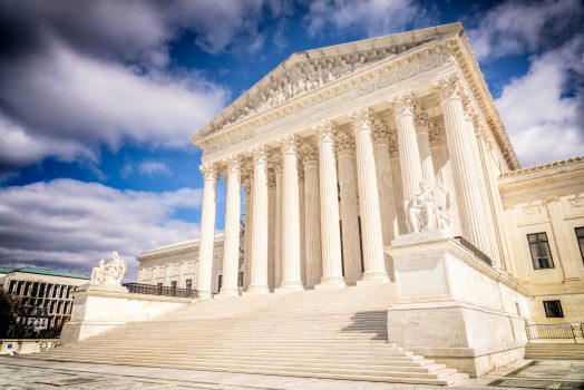 A view looking up the long staircase towards the columns and facade of the Supreme Court Building in Washington DC.
